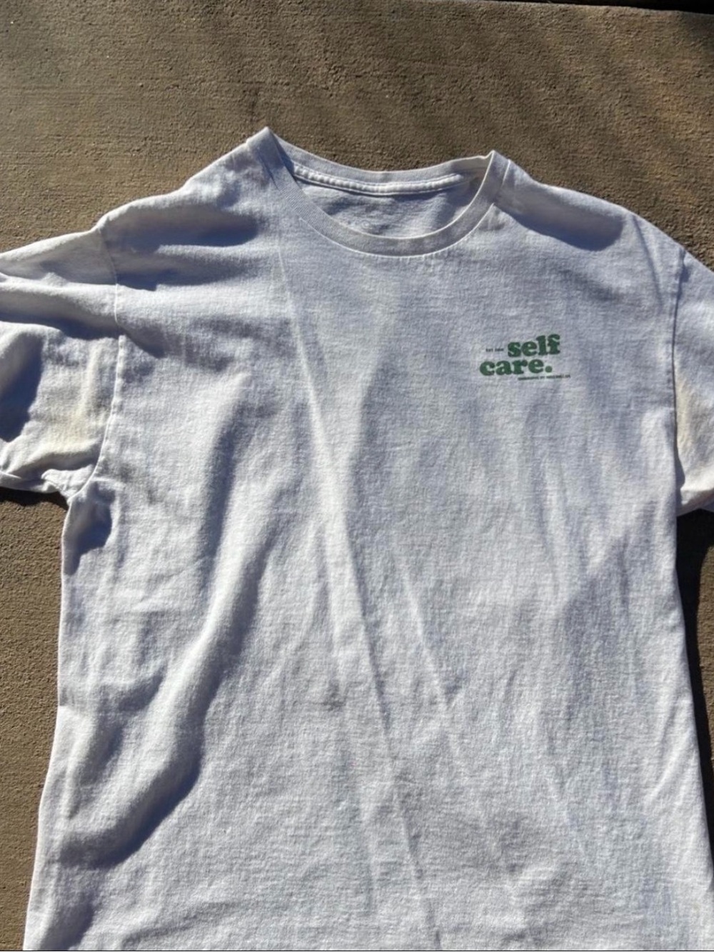 Kids White T‑Shirt with Green "self care." Print